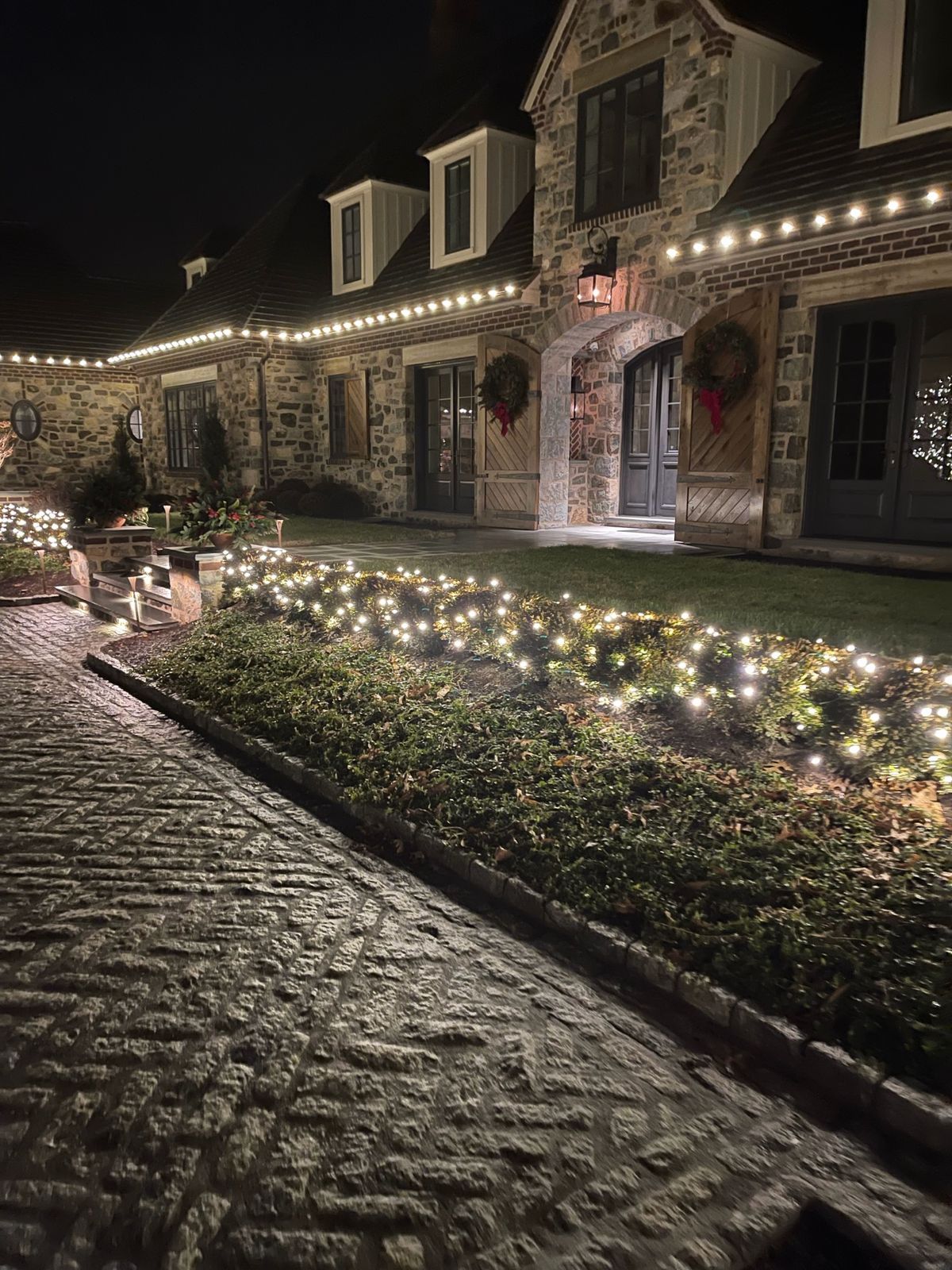 Professional Christmas lights on a colonial home roofline