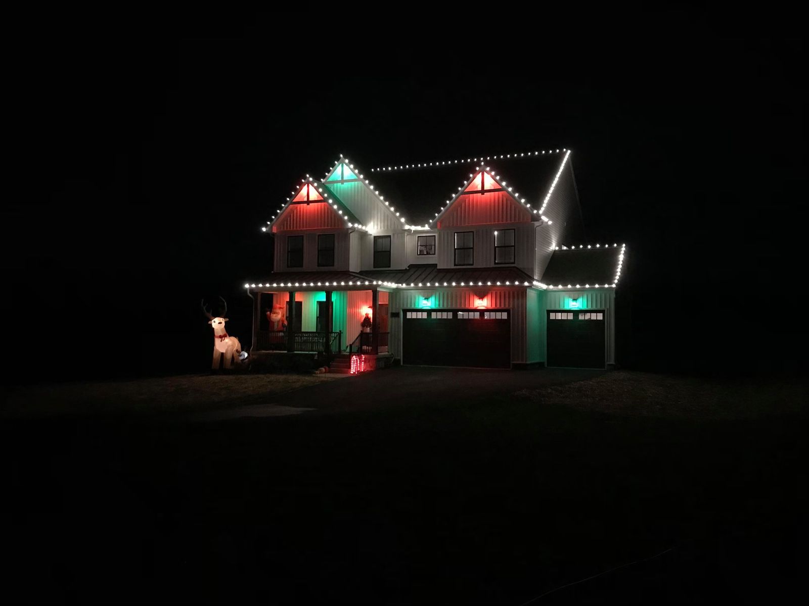 Christmas light installation on a large suburban home