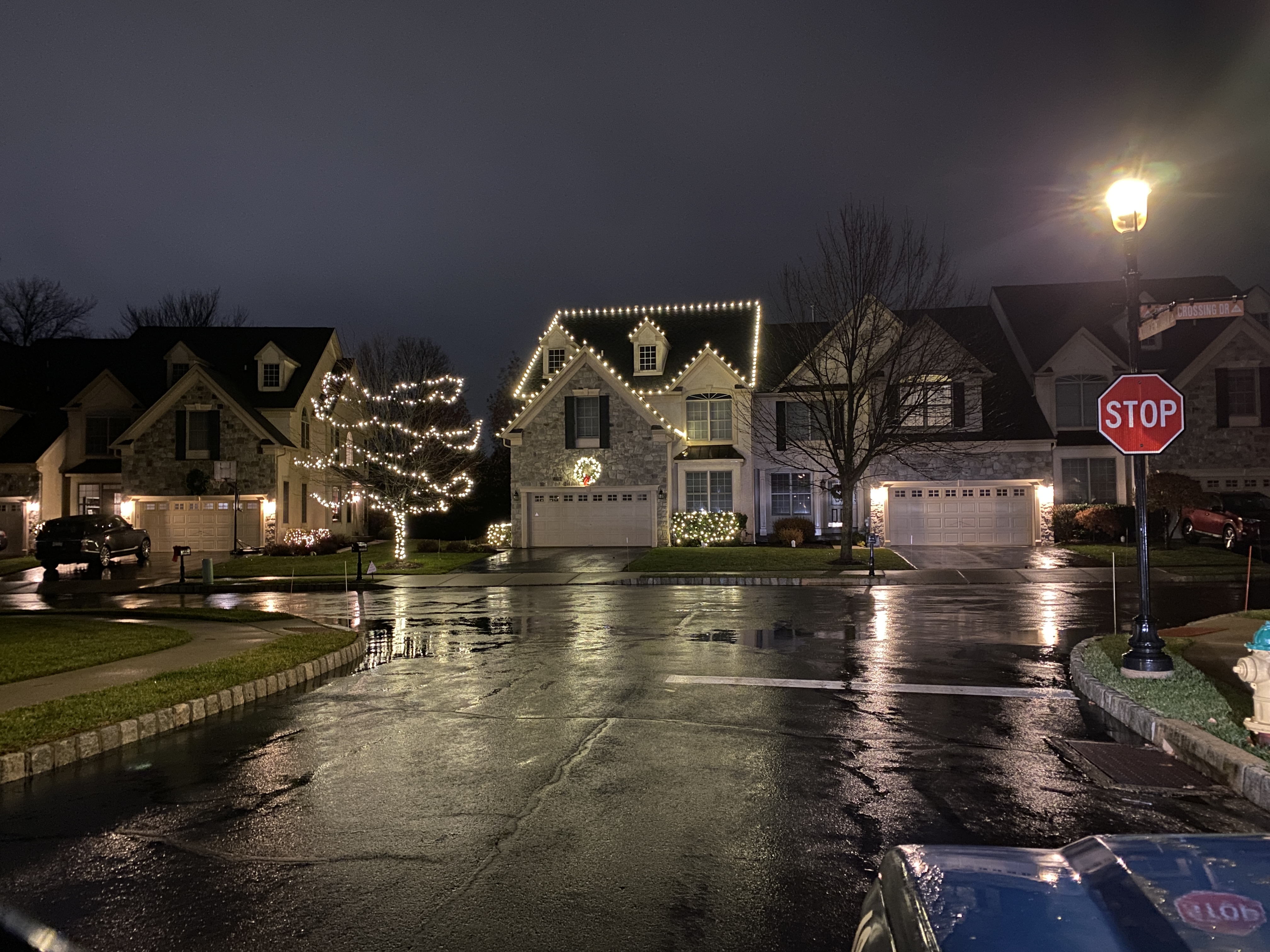 Christmas roofline and tree lighting viewed across an East Norriton neighborhood
