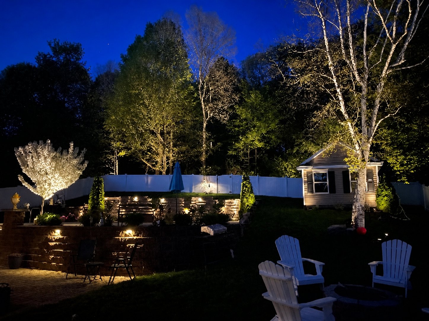 Landscape lighting highlighting a front porch and columns