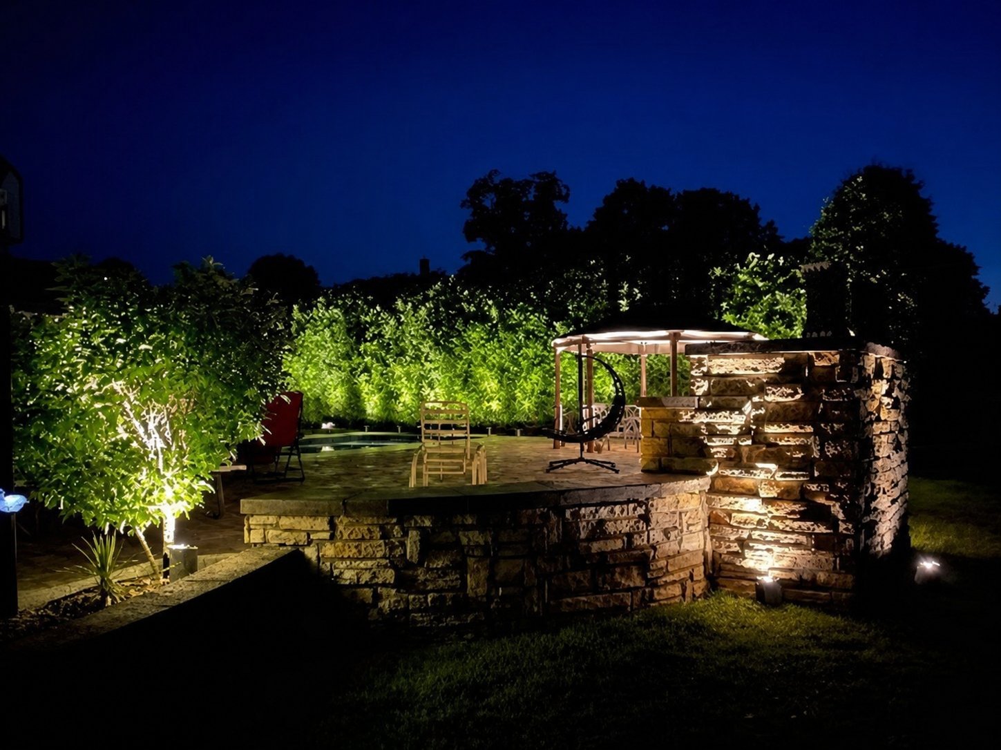 Full-property landscape lighting viewed from the street