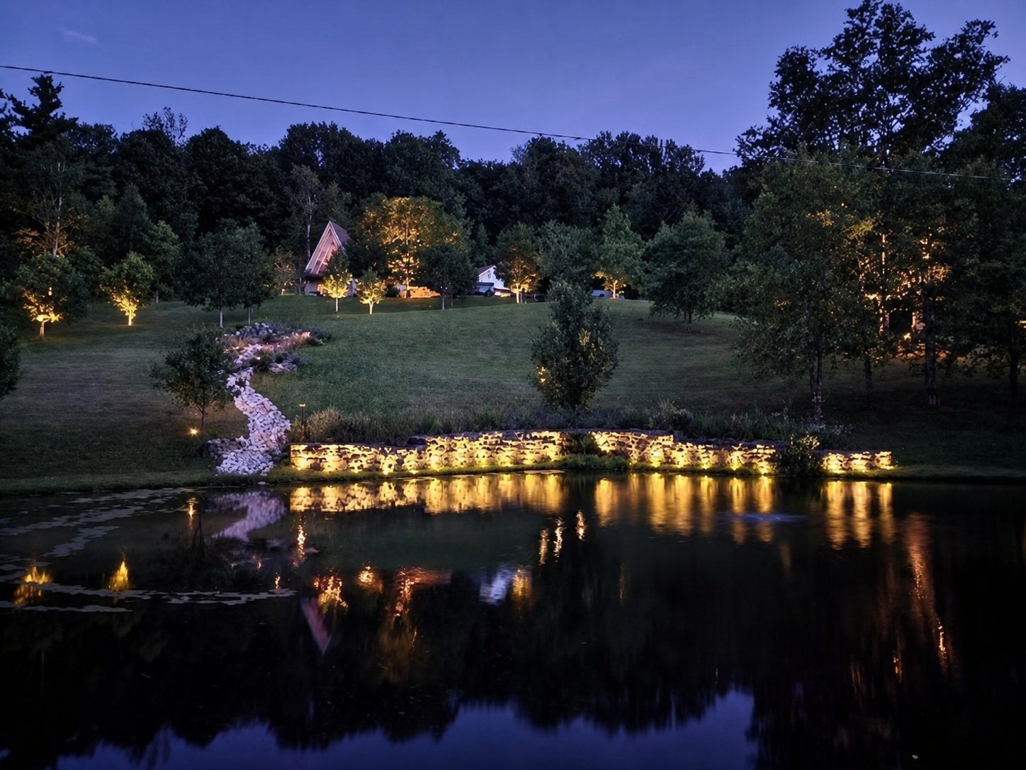 Uplighting on a stone facade with pathway coverage